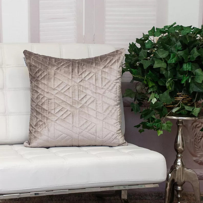 Taupe quilted throw pillow with geometric diamond pattern and piped edges