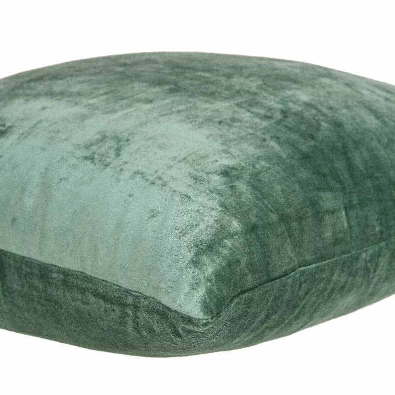 Green solid throw pillow side view with textured top panel and seam