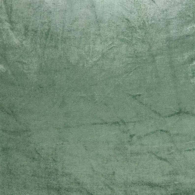 Green textured throw pillow fabric close-up with mottled finish