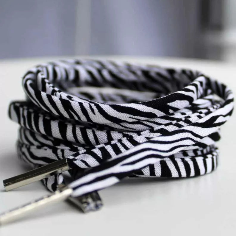 Zebra-print shoelaces, black-and-white striped with metal aglet tips