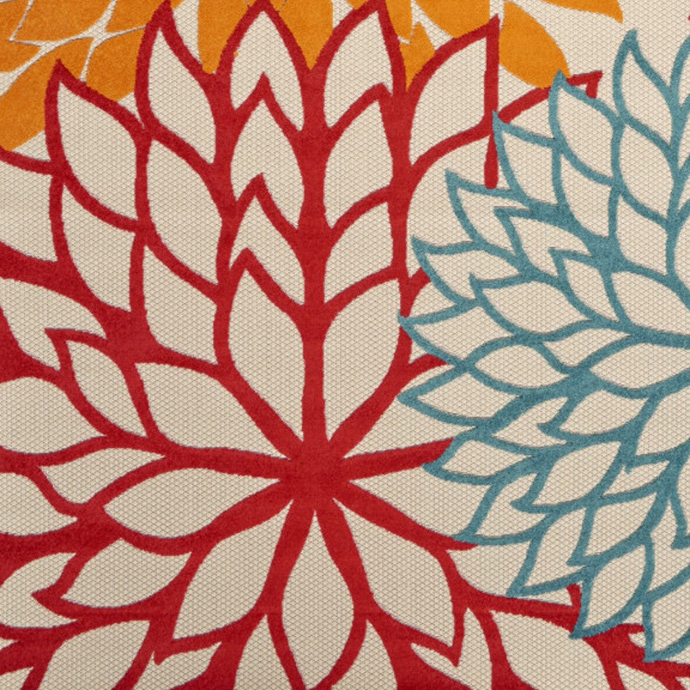 Ivory area rug with red flower and blue-green leaf pattern, close-up