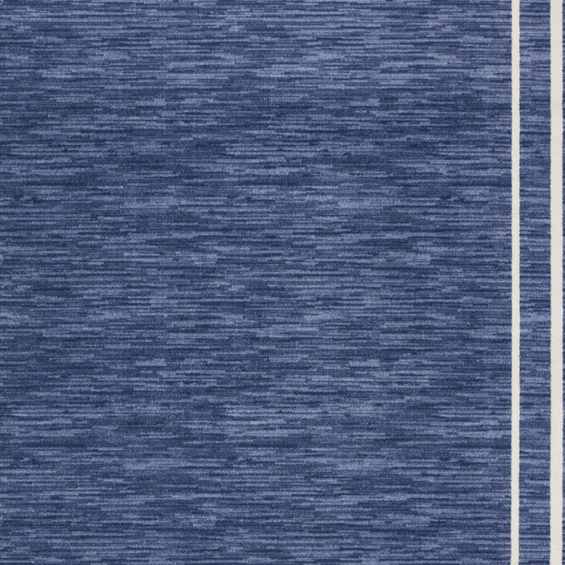 Navy area rug surface texture with thin ivory inner border line