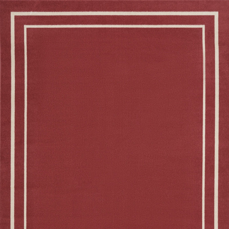 Brick red area rug with ivory square border lines, close-up of center panel