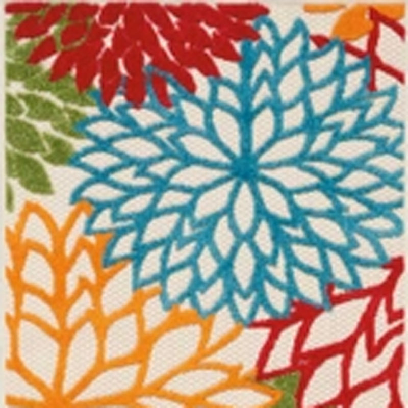 Floral runner rug close-up with blue starburst flowers, red accents, and green ground.