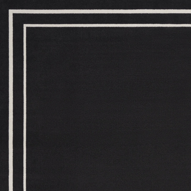 Black area rug featuring an ivory square border inside a thicker ivory frame