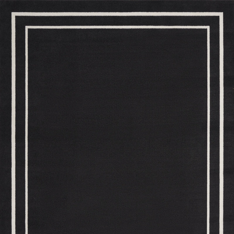 Black area rug with ivory double-line square border pattern