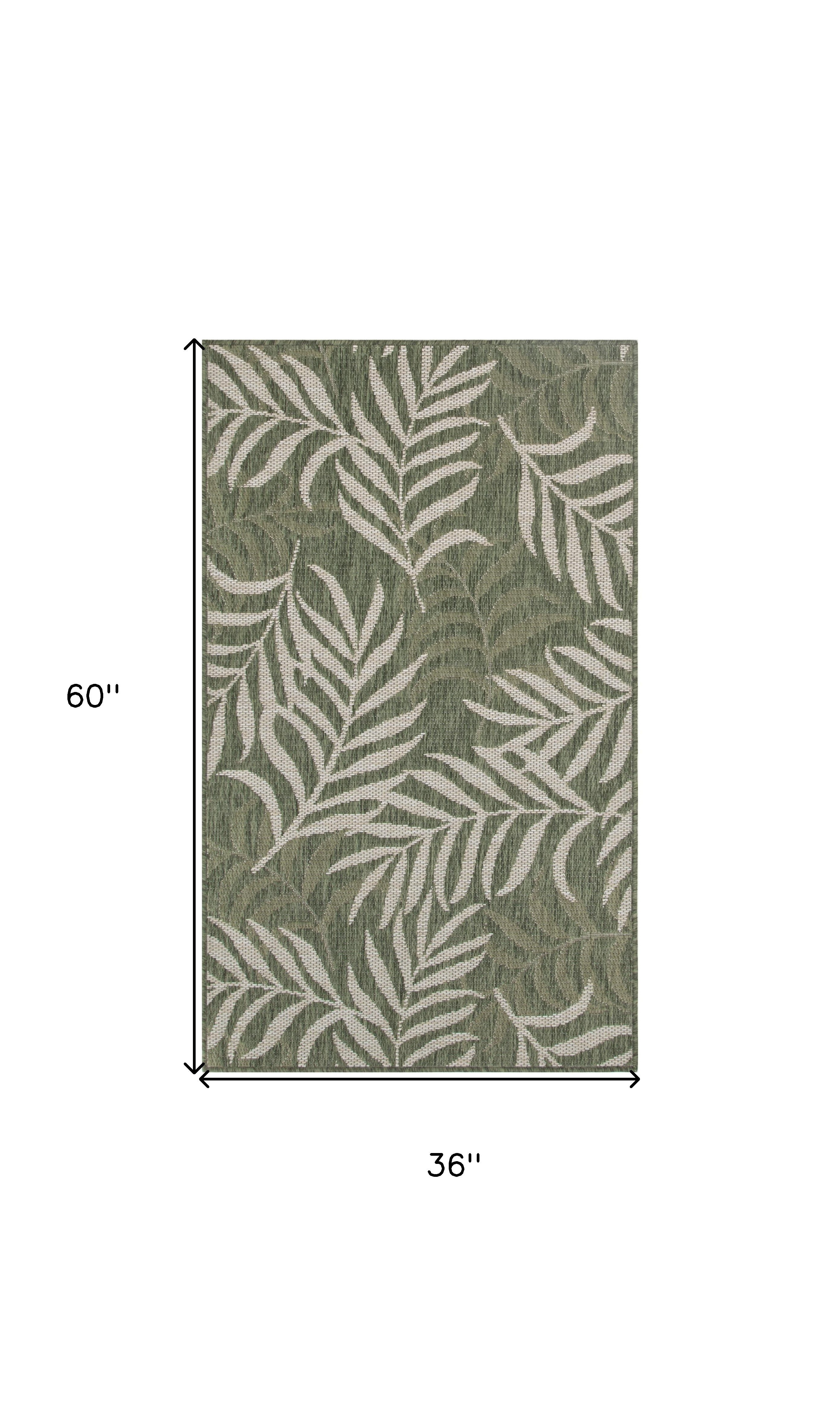 Green and ivory palm leaf indoor outdoor area rug, 60 x 36 inches