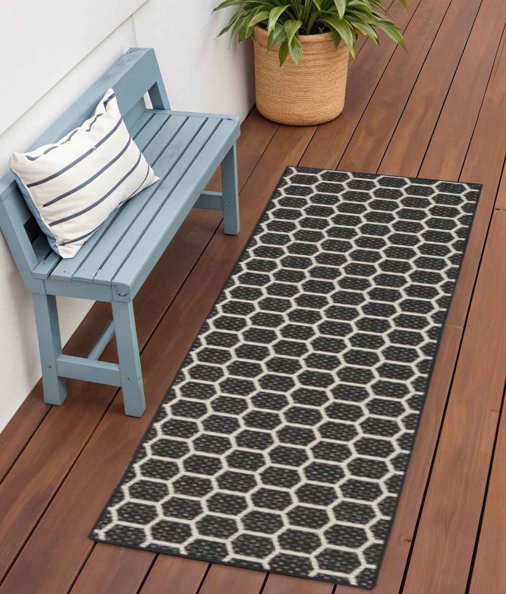 6' Black And Ivory Geometric Indoor Outdoor Area Rug