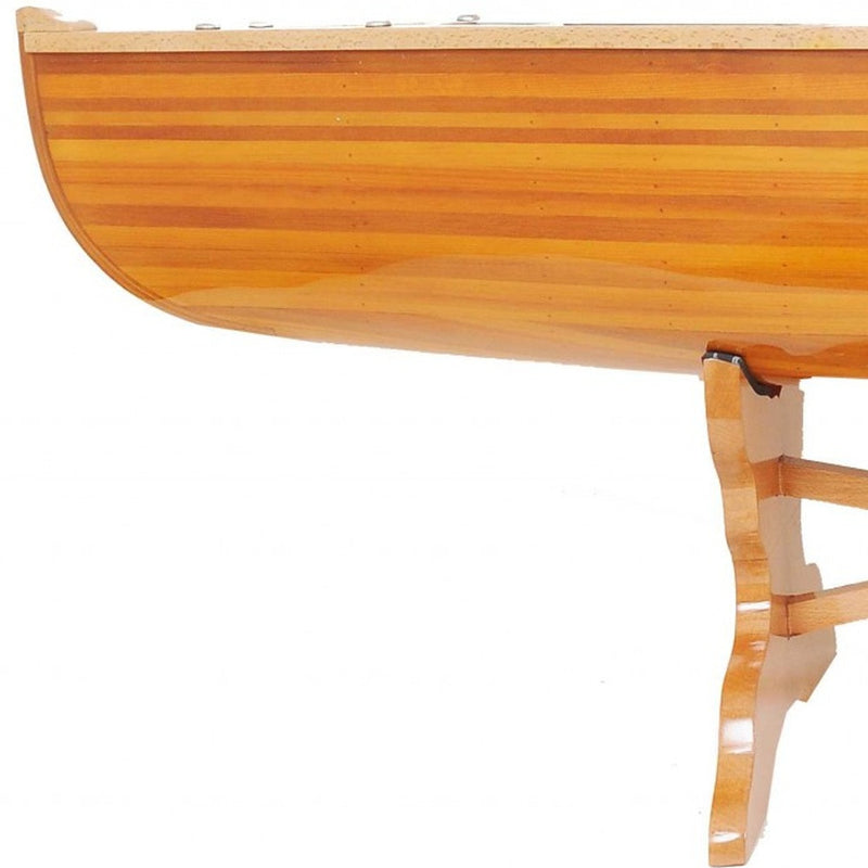 Canoe-shaped wooden coffee table end view with visible leg support