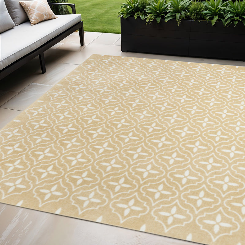 Beige and ivory geometric patterned area rug on outdoor flooring.