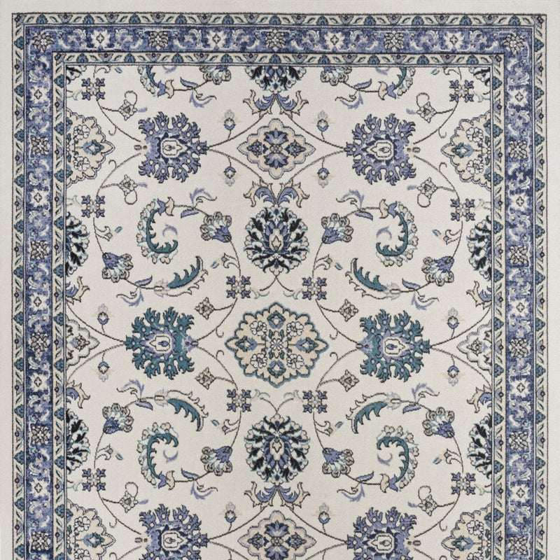 Ivory and blue traditional floral area rug with central medallions and corner motifs