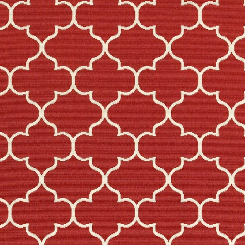 Red indoor/outdoor area rug showing repeating ivory quatrefoil trellis motif