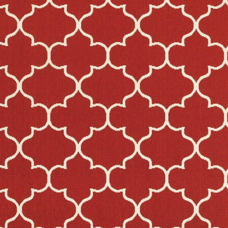 Close-up of red indoor/outdoor area rug with ivory quatrefoil trellis pattern