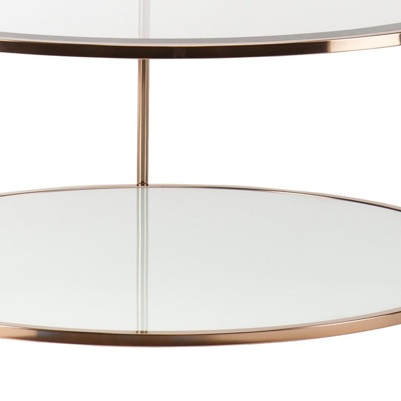 Round coffee table with clear glass and gold iron frame, close-up of tabletop rim