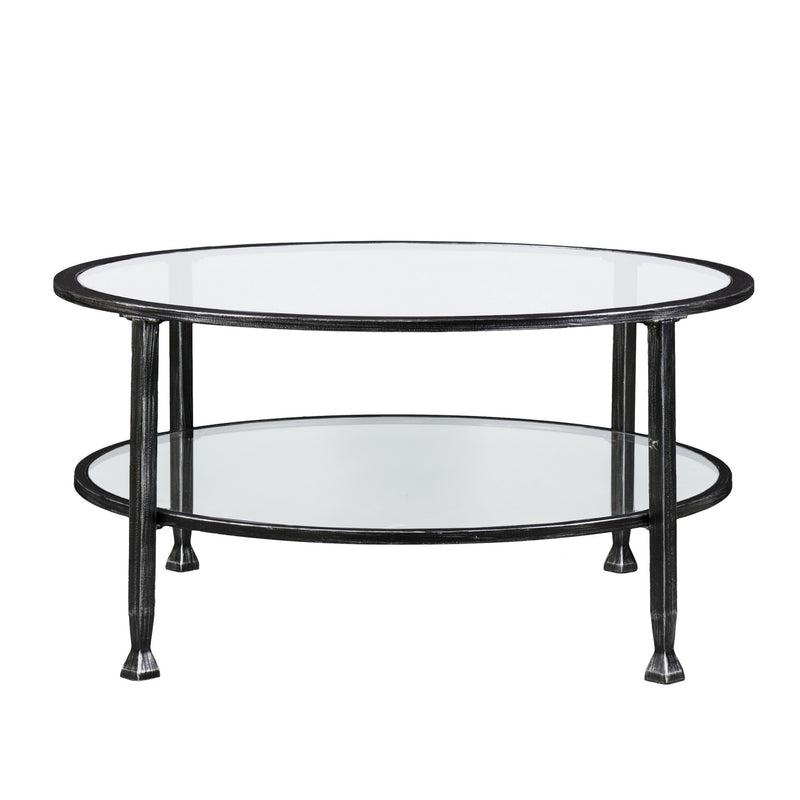 Round coffee table with black metal legs and two clear glass shelves