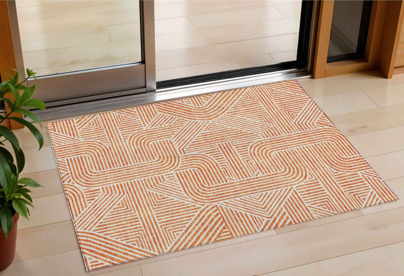 3' X 5' Orange And Ivory Abstract Washable Indoor Outdoor Area Rug