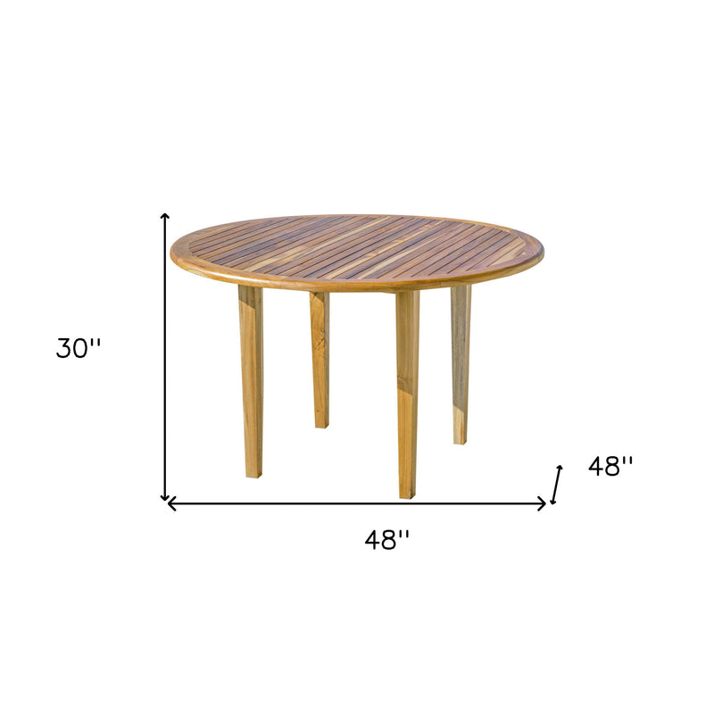 Round outdoor dining table, 48 in wide and 30 in high, natural wood with dark top