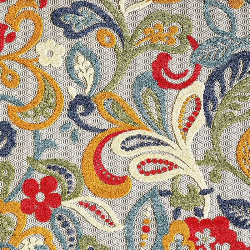 Close-up Jacobean floral rug texture with swirls, leaves, and red flower details
