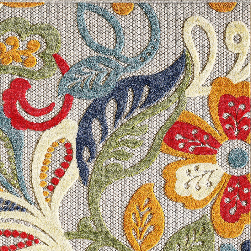 Close-up Jacobean floral rug pattern with navy, teal, orange, and red leaf motifs