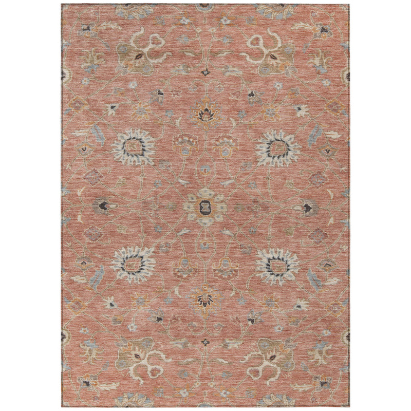 Rectangular pink area rug with repeating floral medallions in gray and beige