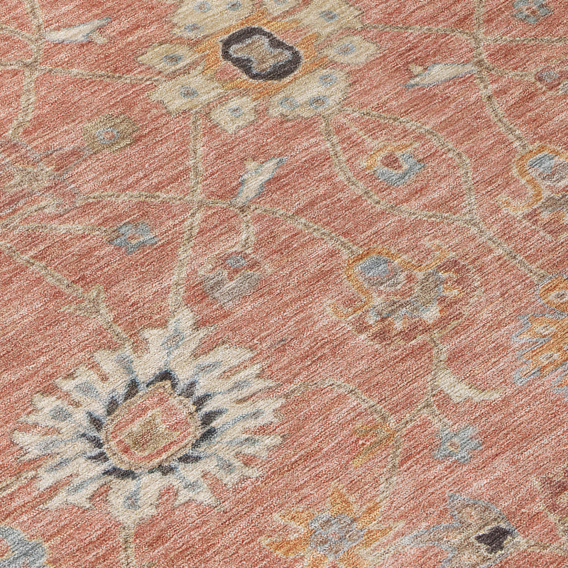 Close-up of pink area rug floral pattern with gray and beige details