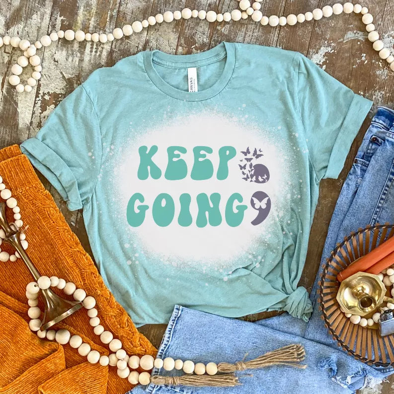 Teal short-sleeve crewneck T-shirt with bleached speckle and 'KEEP GOING' print