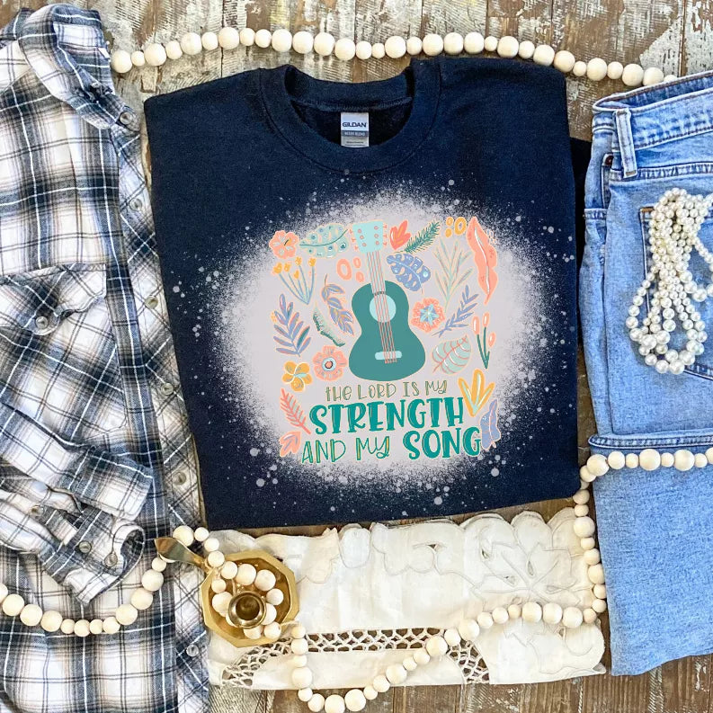 Dark navy crewneck tee with colorful floral 'Strength' and 'My Song' lettering