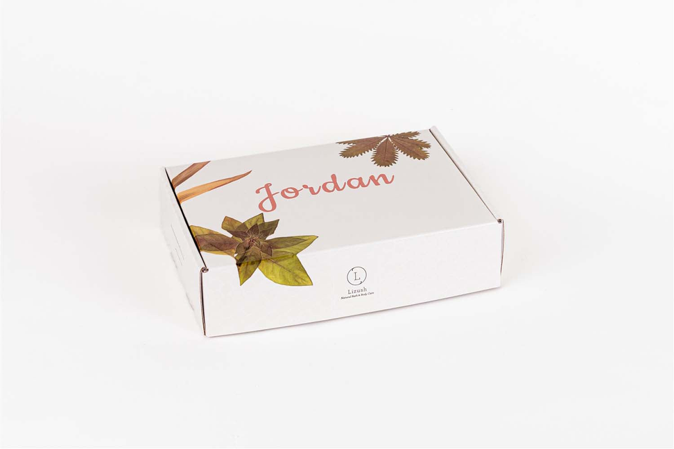 Handmade soap gift box with botanical leaf design and ribbon detail on white background