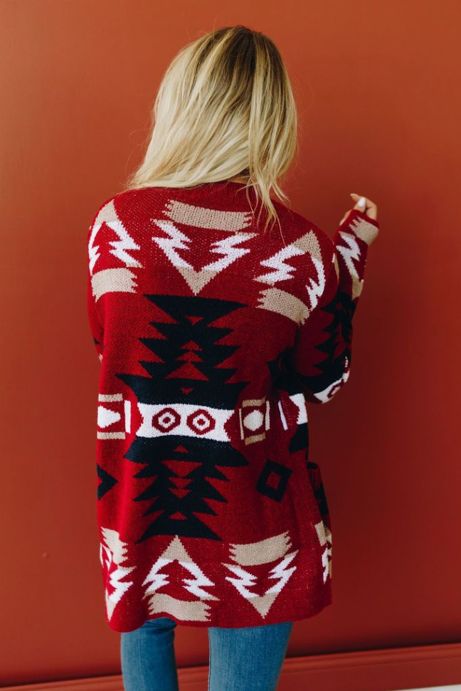Back of patterned knit cardigan with red, navy, and white geometric motif, long sleeves