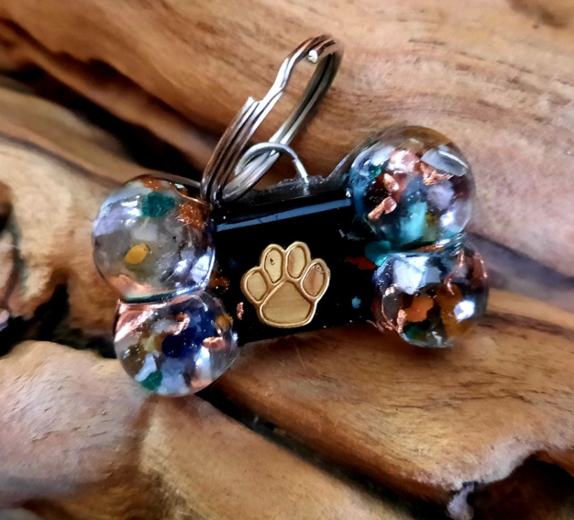 Dog bone pet charm with gold paw emblem and multicolor bead clusters