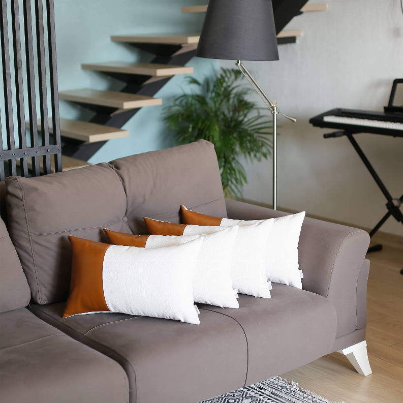 Vegan faux leather throw pillow set (4) with orange faux leather fronts and white cushions