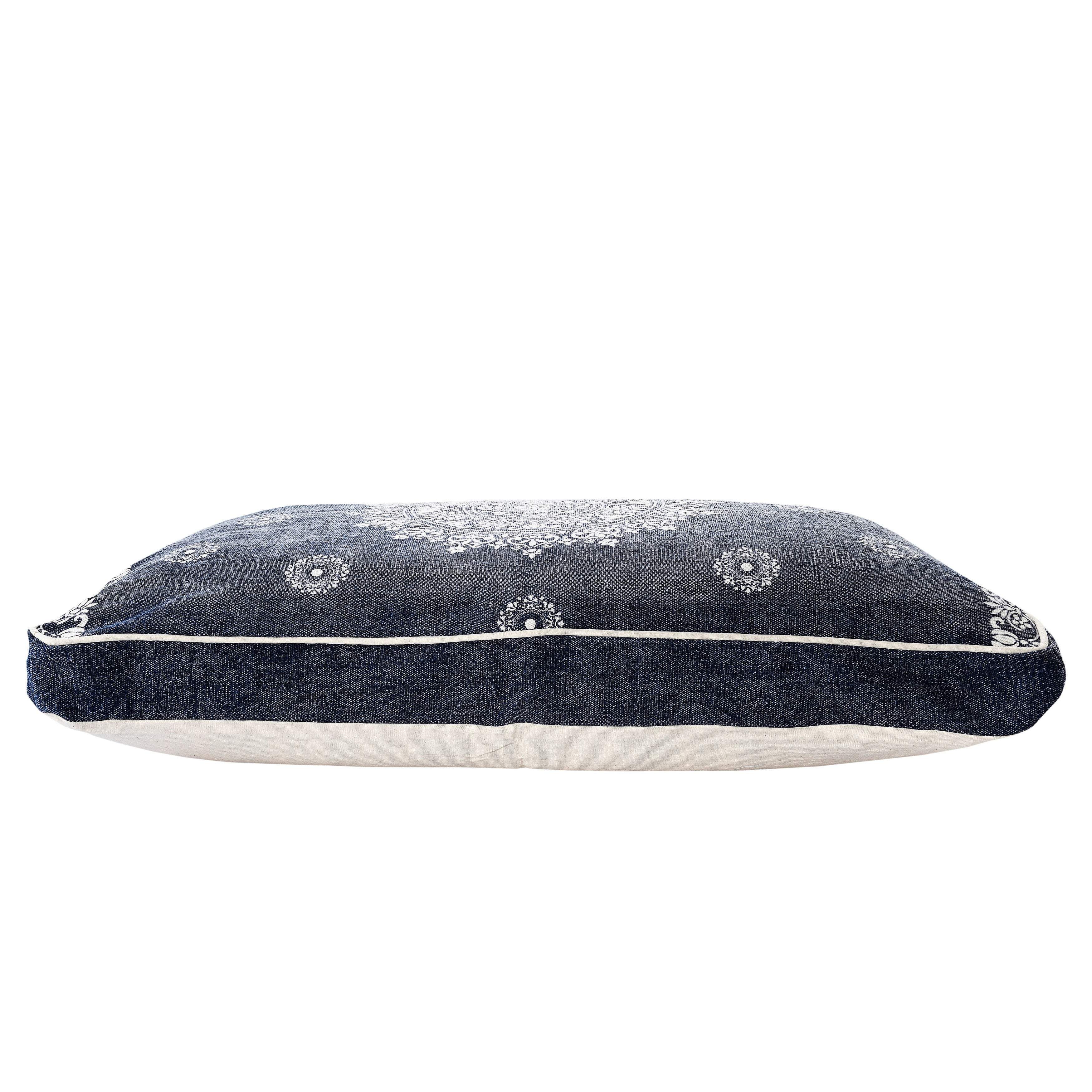 Navy blue decorative pillow with white floral pattern, made of soft fabric, perfect for adding style to any room.