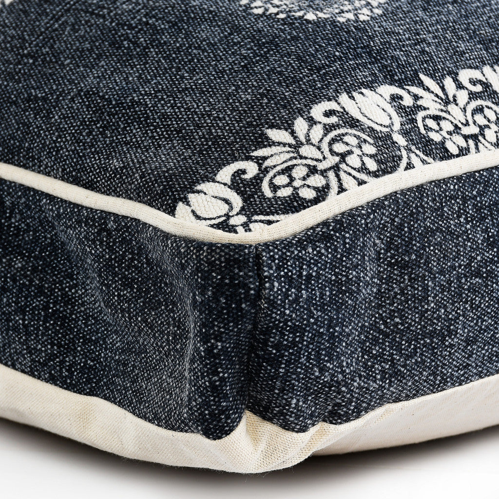 Navy blue denim decorative pillow with white floral embroidery and cream piping. Stylish and versatile home accent.