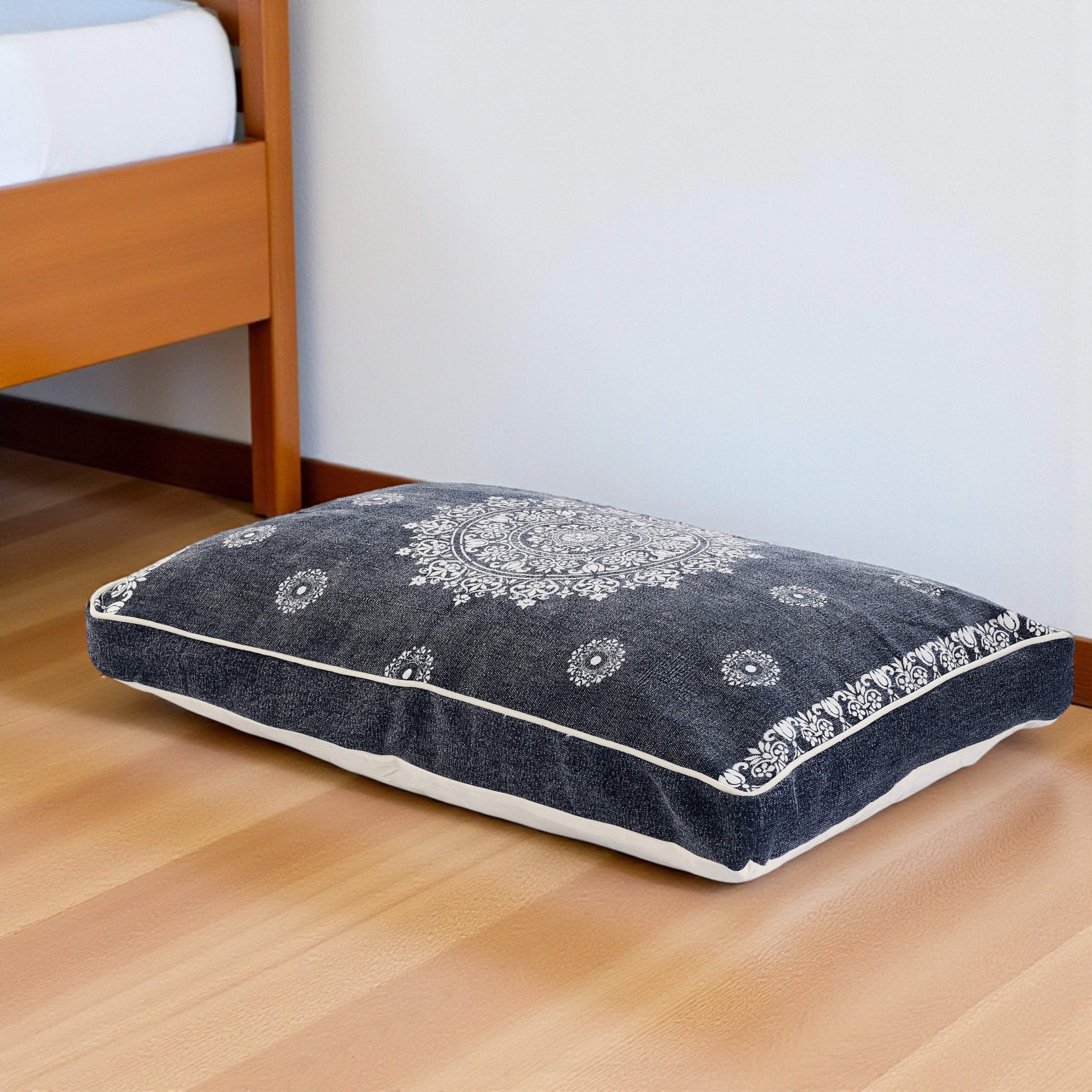 Dark blue patterned floor pillow with intricate white mandala design, perfect for bohemian decor or cozy seating.