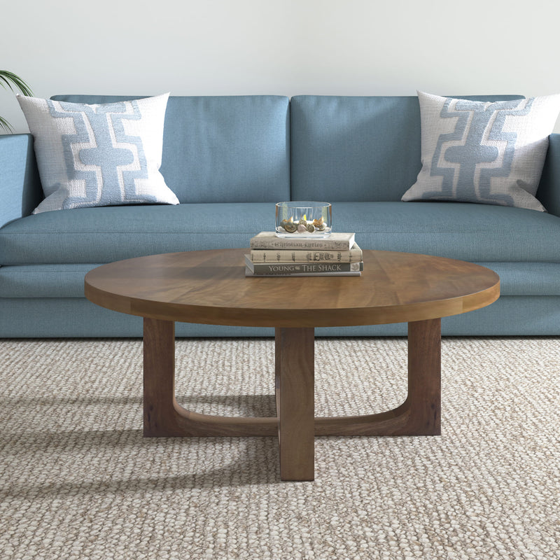 Brown round coffee table with solid wood legs and open cross-brace base