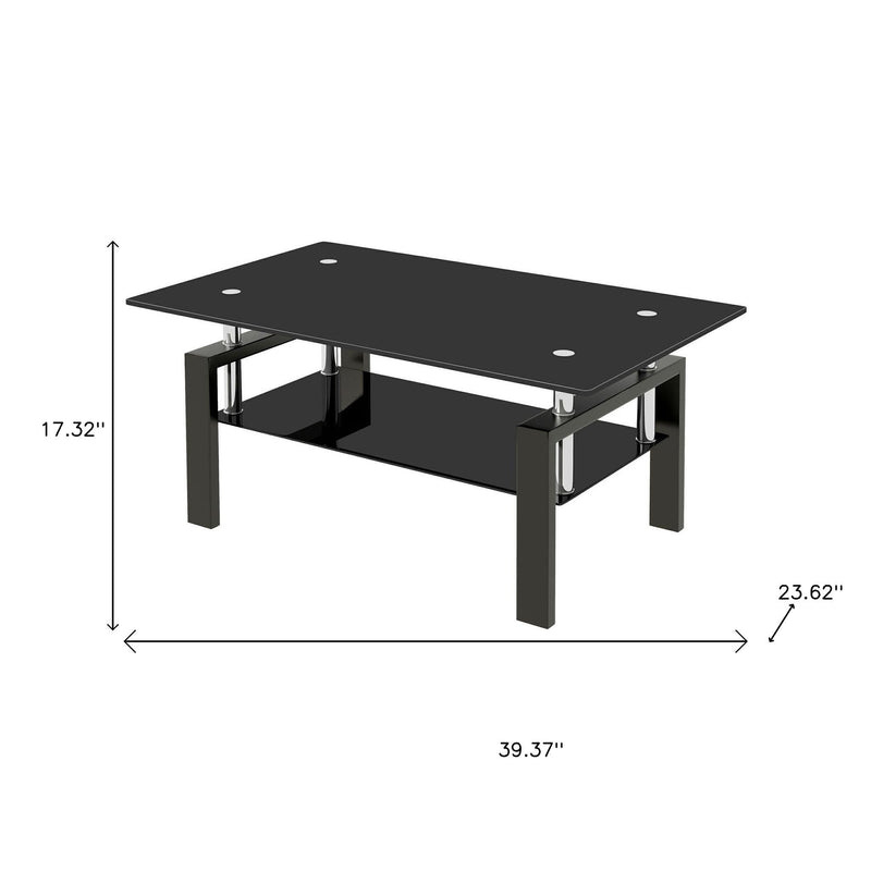 Black glass coffee table on four chrome posts and black steel frame
