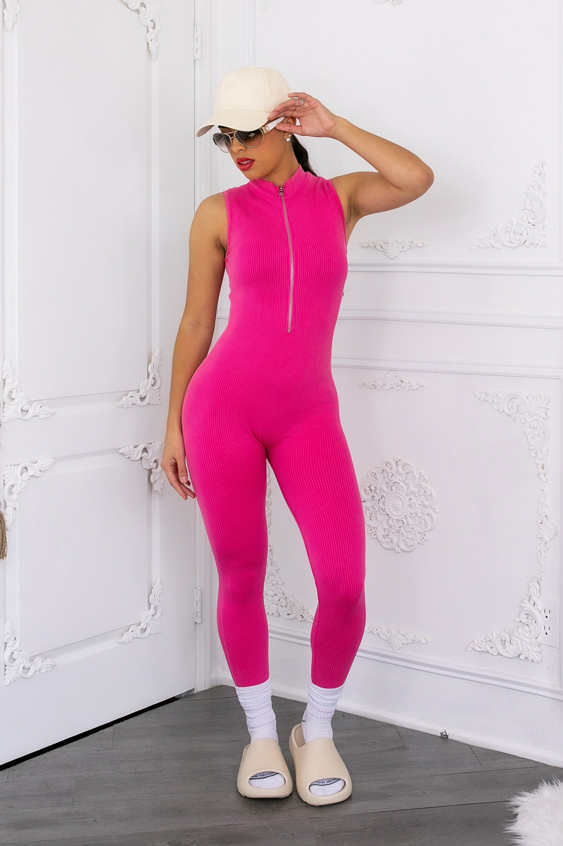 Pink sleeveless mineral-wash jumpsuit with front zipper and fitted ankle length