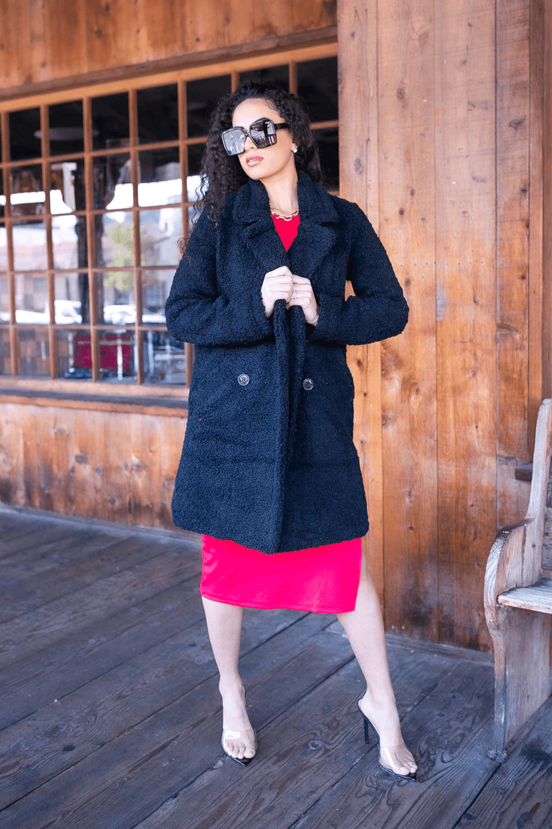 Black double-breasted faux fur teddy coat with button front and long sleeves
