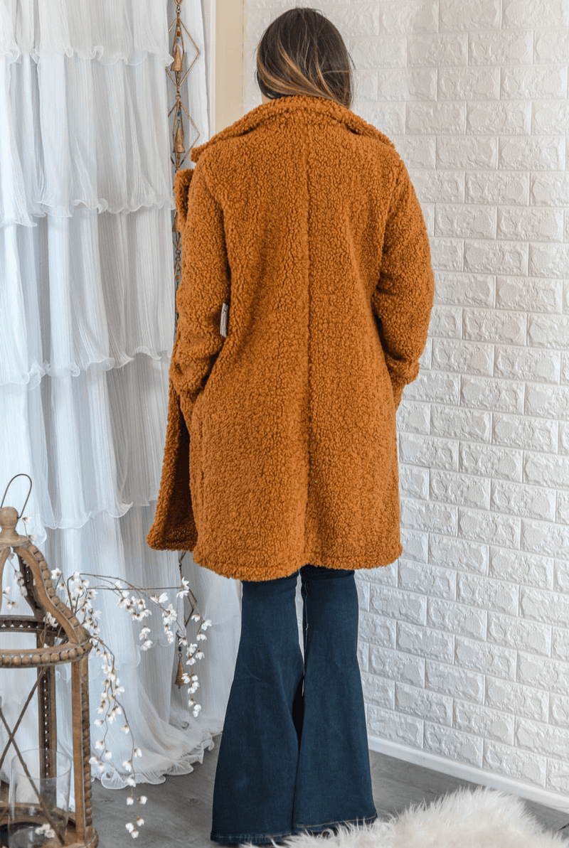 Camel faux fur teddy coat with double-breasted button front and long sleeves