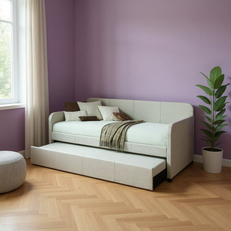 Light gray upholstered twin bed frame with pull-out mattress and panel headboard