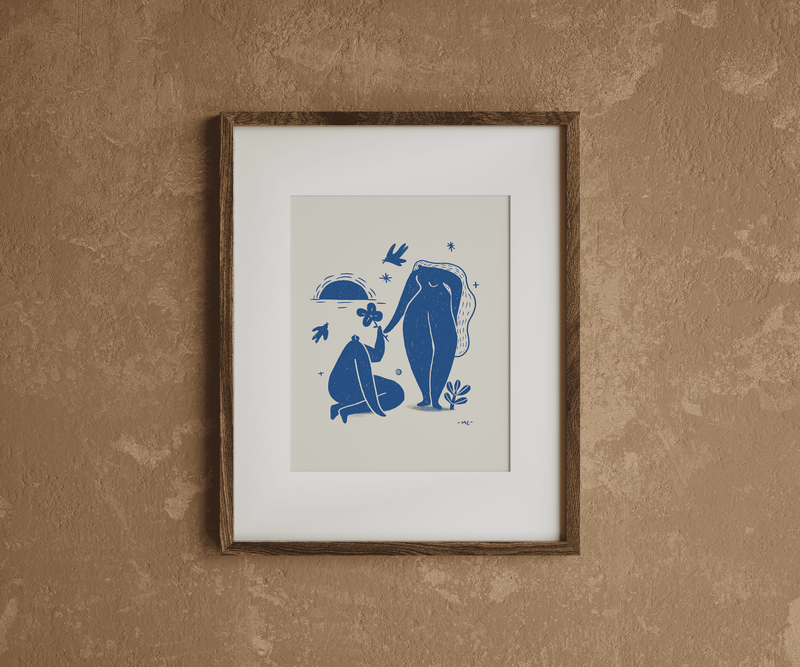 Wood-framed blue line-art print showing two figures and botanical details on white mat