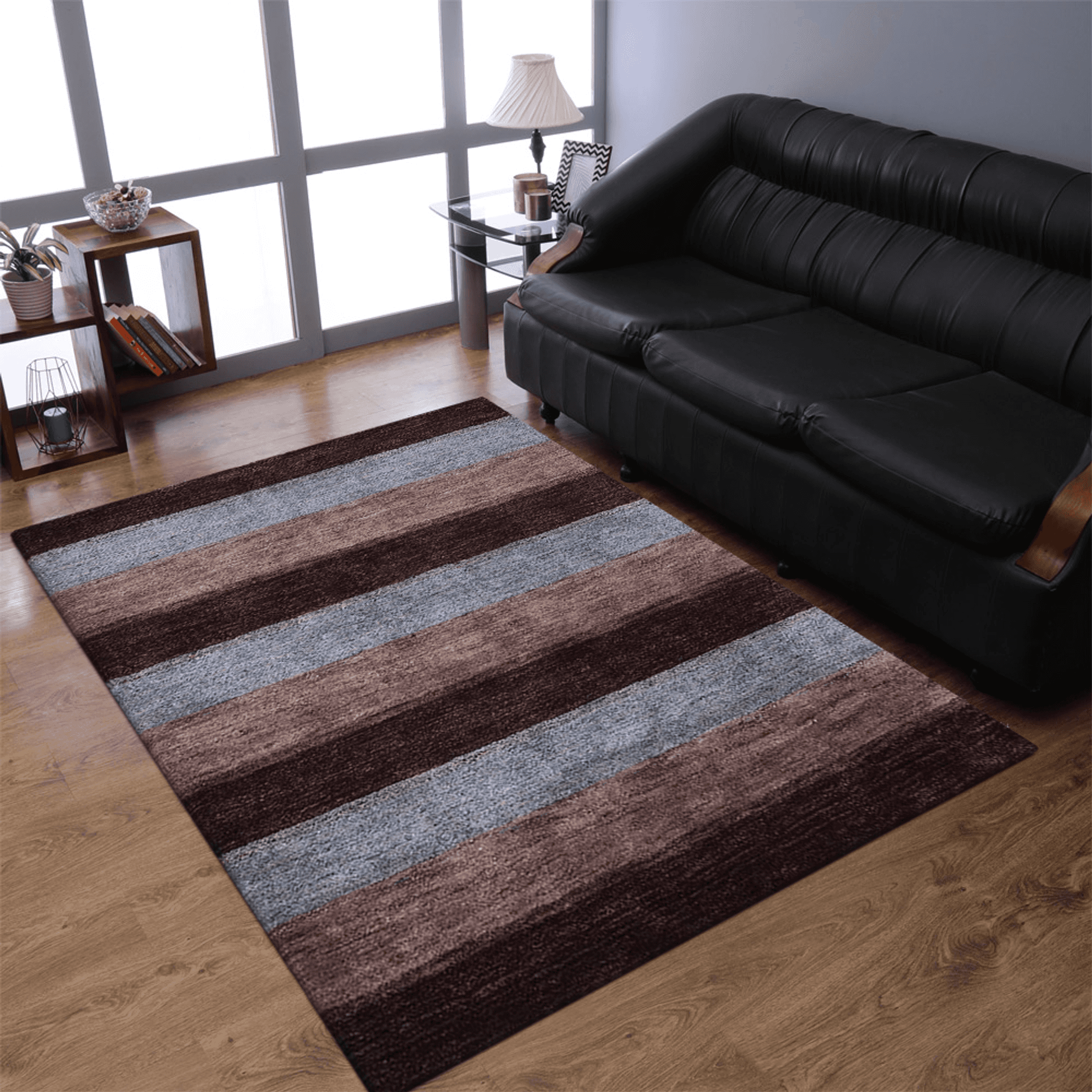Striped area rug with maroon, brown, and blue horizontal bands on wood flooring