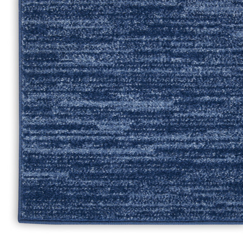 Blue runner rug surface close-up with mottled texture and horizontal striations.