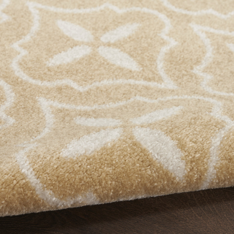 Beige and ivory geometric area rug corner view; low-pile texture with white pattern.