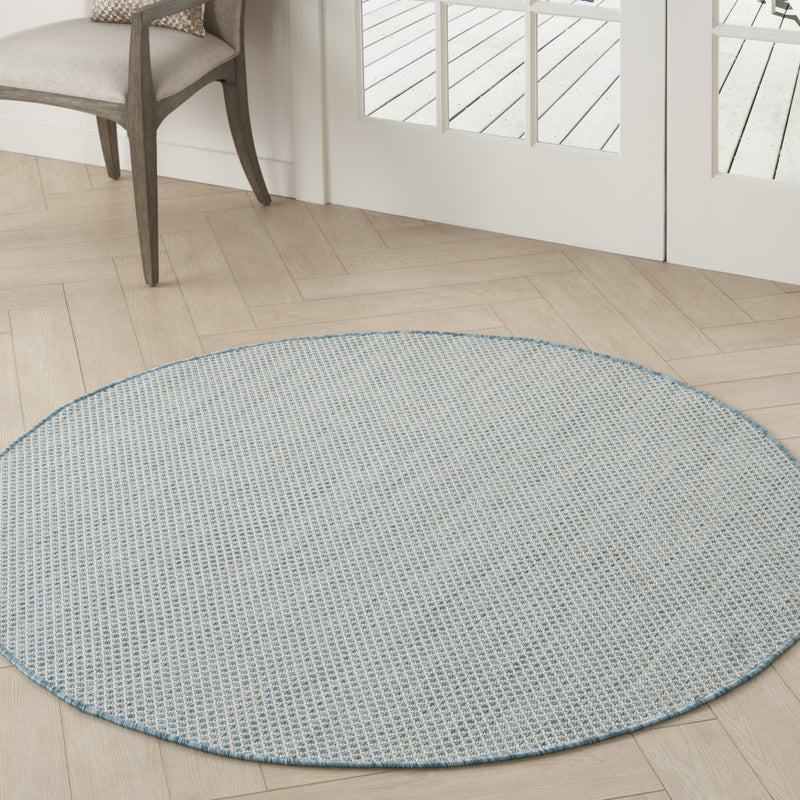 Round blue geometric power loom area rug, fine grid lattice with narrow blue binding edge