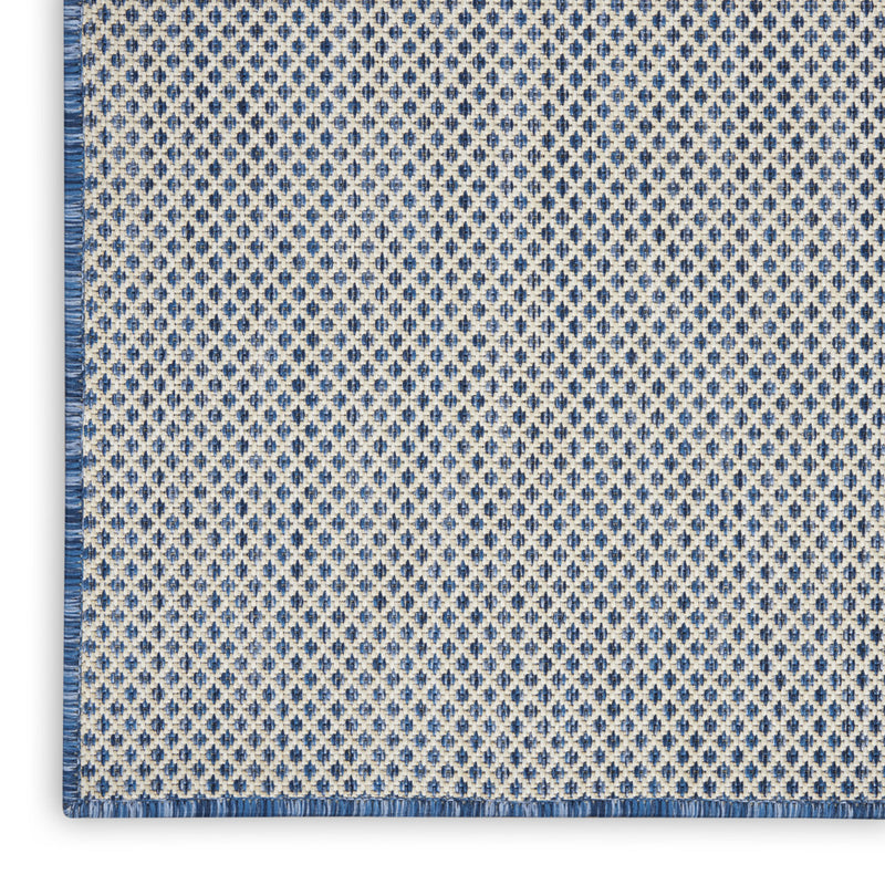 Indoor/outdoor area rug with blue diamond pattern and flat bound edge