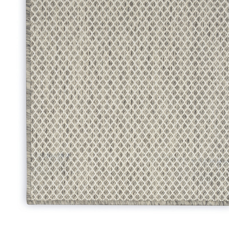 Ivory area rug with small geometric diamond pattern and subtle silver flecking