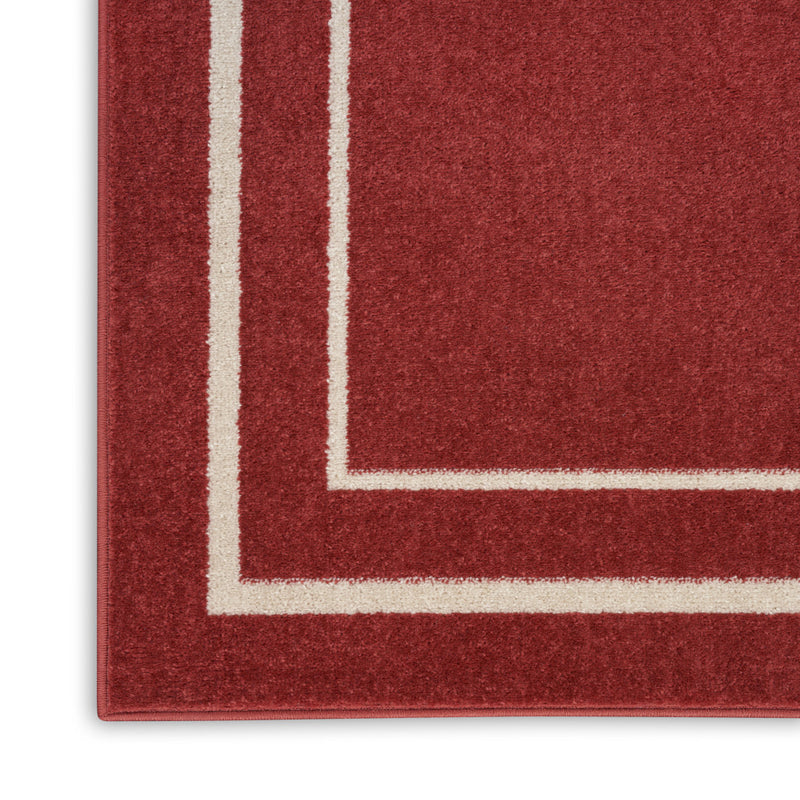 Red rug edge with ivory nested rectangle border and textured surface