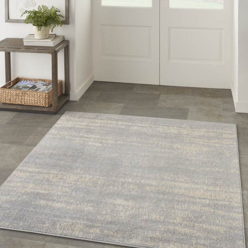 Square indoor/outdoor area rug, gray and beige abstract pattern, flatweave look.