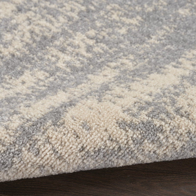 Square abstract area rug with gray and beige tones and short textured pile.